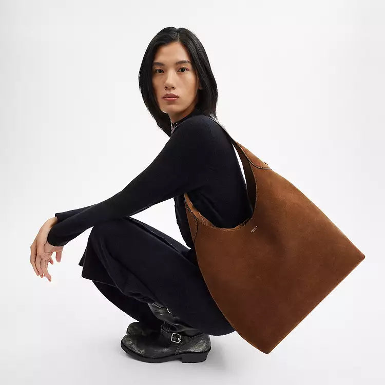 Coach CW636 suede Brooklyn 39 shoulder bag with brass hardware in warm brown color, featuring a sleek, compact design.