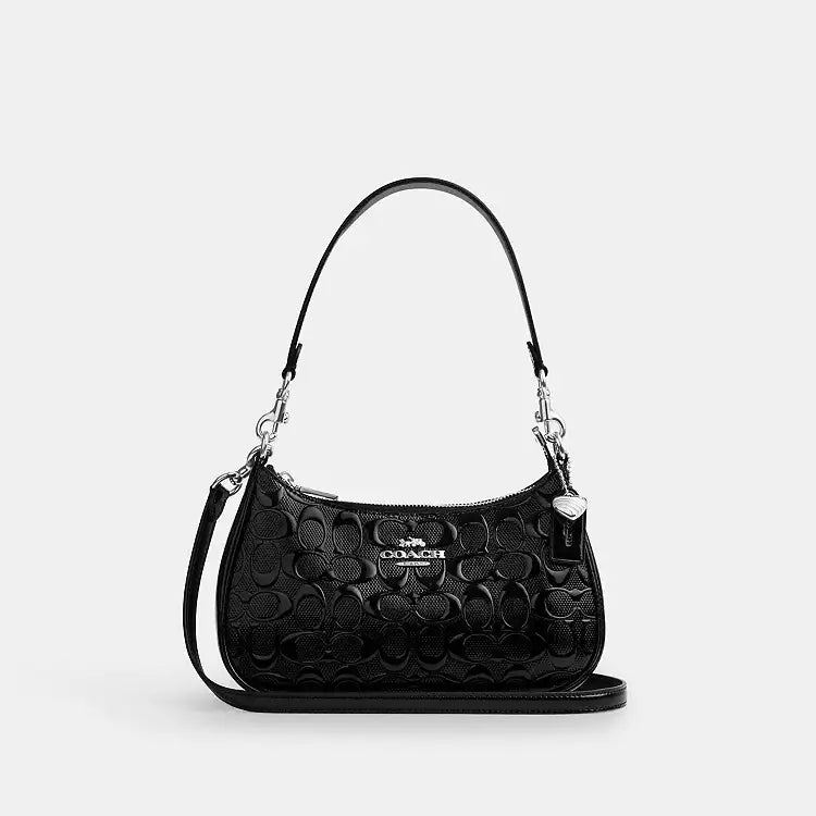 Coach Teri Shoulder Bag in signature leather with heart charm, featuring a stylish design and compact shoulder bag style.
