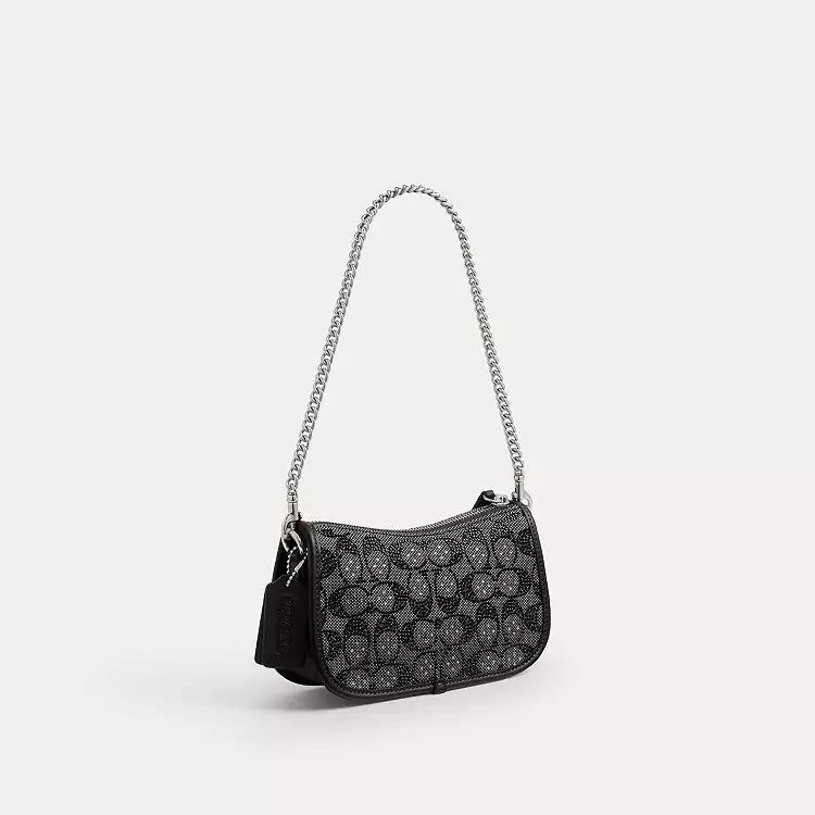 Coach Swinger 20 shoulder bag with chain in crystal signature jacquard in black, featuring signature pattern and elegant design.