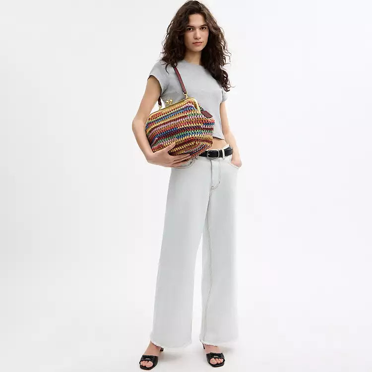 Multicolor straw Coach large Kisslock shoulder bag with gold hardware and spacious interior, featuring a classic design.