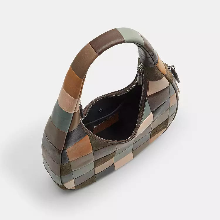 Coach Coachtopia Alter/Ego Crescent Shoulder Bag in leather and suede with CCX57 branding, featuring a sleek, curved design.