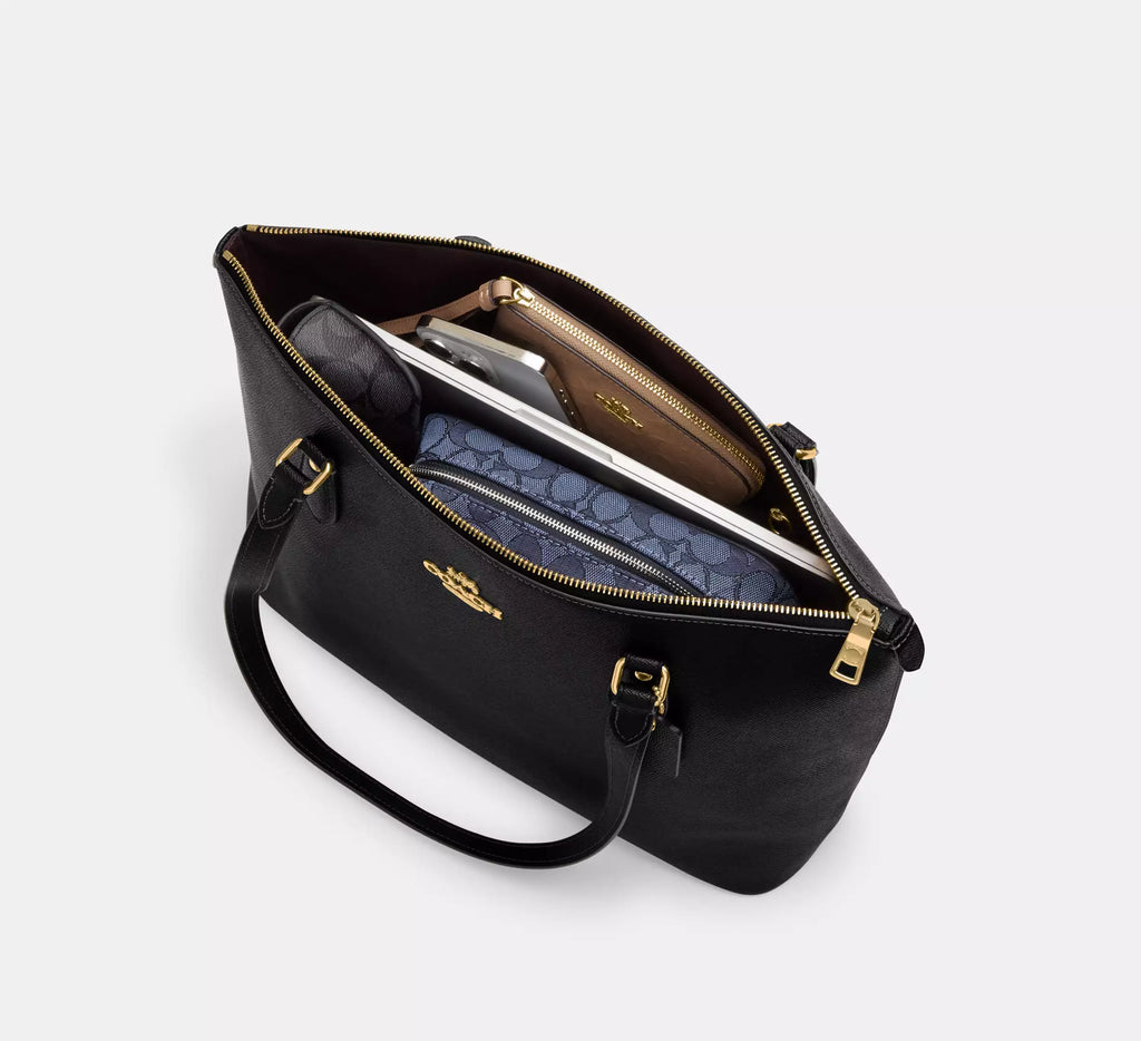 Black and red Coach Station Tote Bag with floral print by The Tiny Bag, featuring sturdy handles and spacious interior.