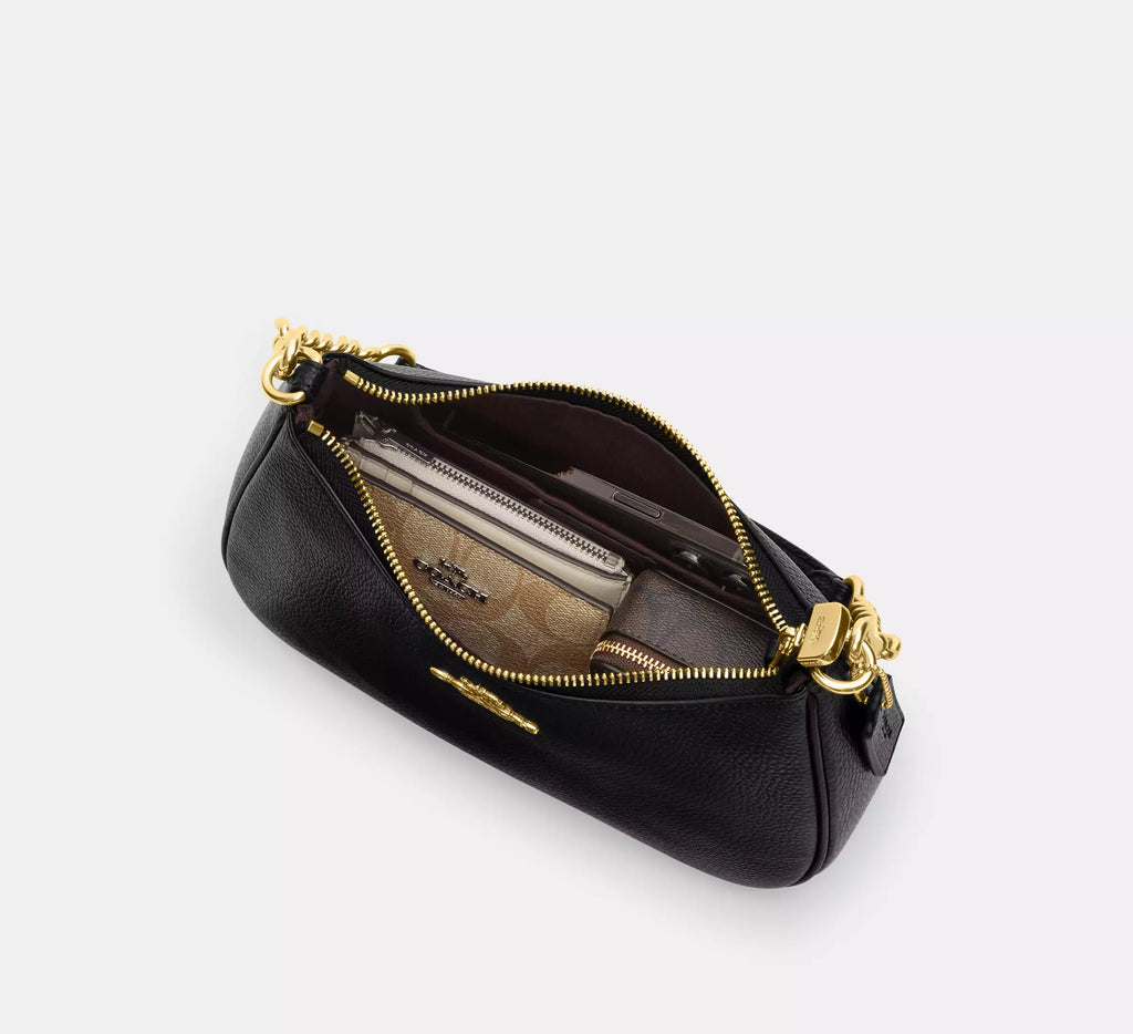 Coach Teri shoulder bag with floral print from The Tiny Bag, featuring a stylish design and adjustable strap.