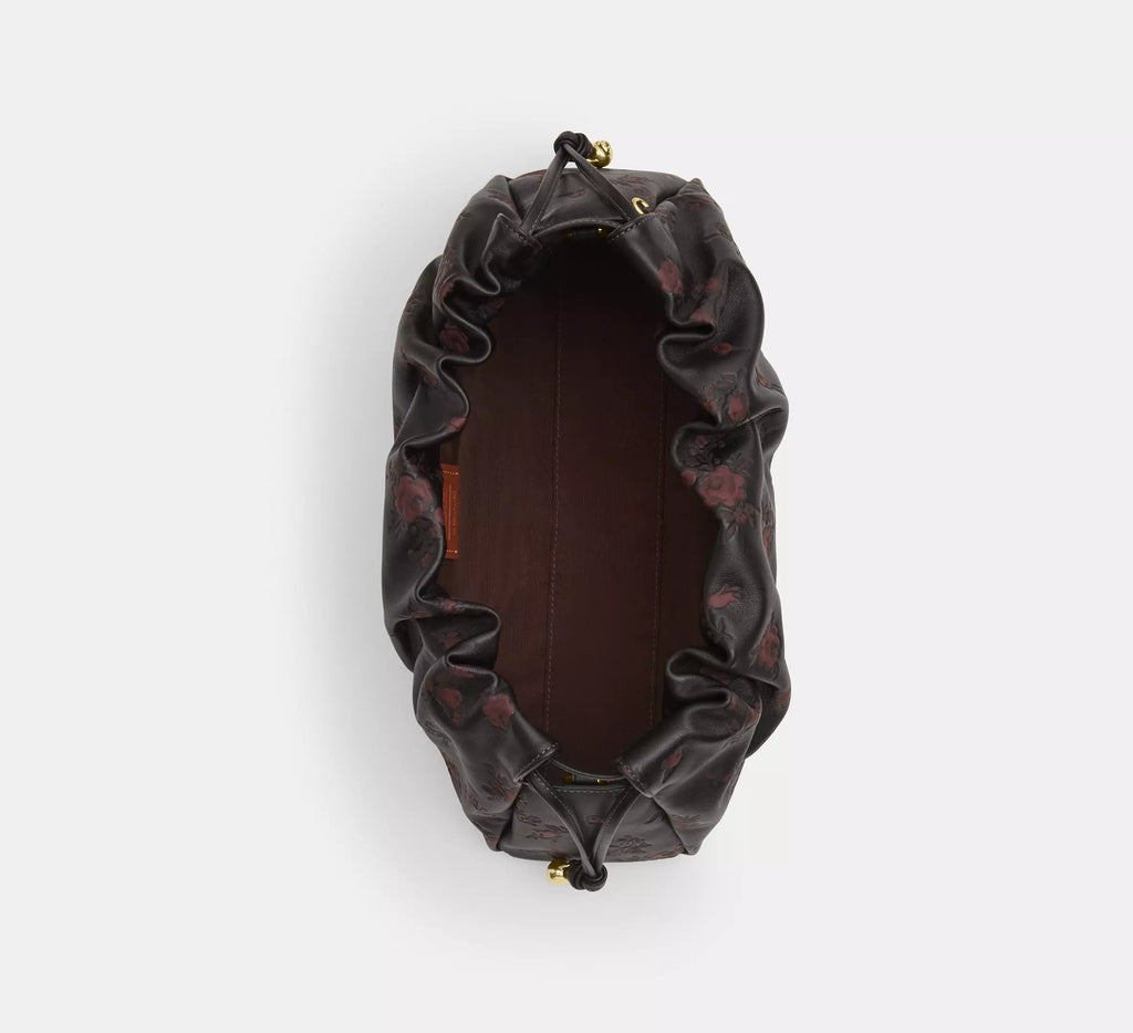 Coach Faye large leather shoulder bag with floral print in black and wine colors, stylish and spacious for everyday use.