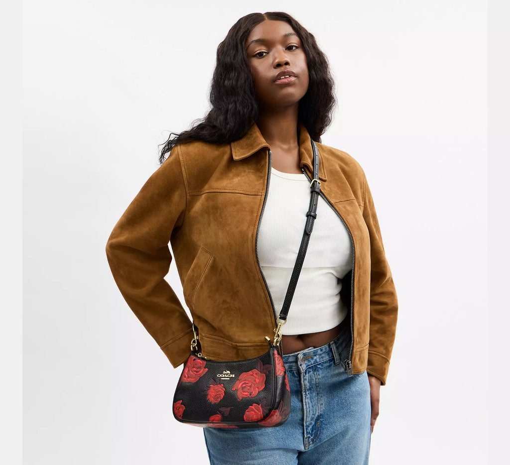 Coach Teri Shoulder Bag with floral print by The Tiny Bag, showcasing a stylish floral design and shoulder strap.