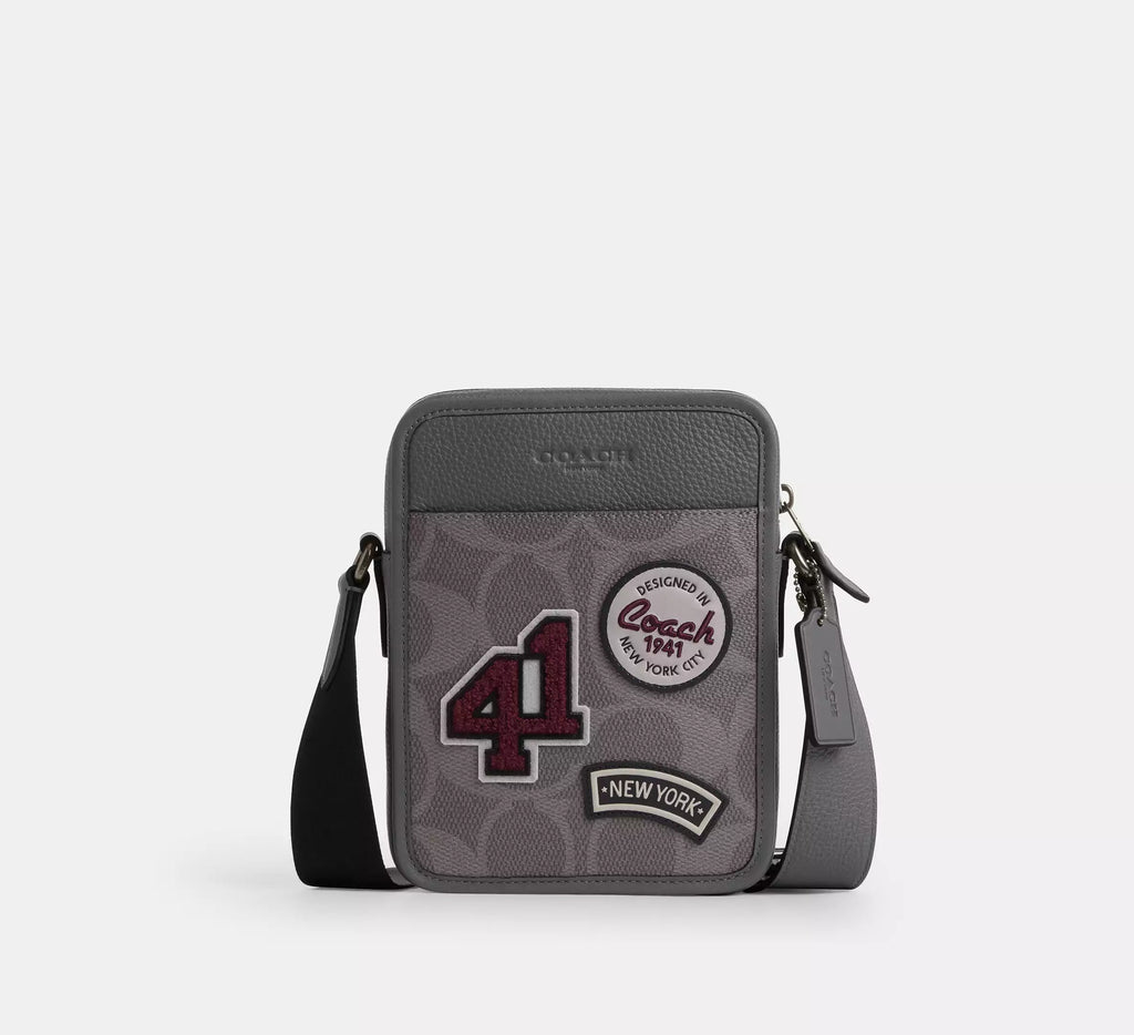 Coach men's Sullivan flap crossbody bag in signature leather and canvas with adjustable strap and front flap pocket.