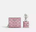 Coach boxed snap wallet with signature canvas in pink and rose, featuring a picture frame charm and compact wallet design.
