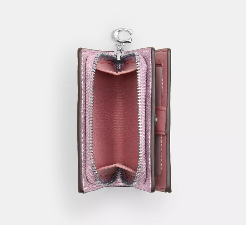 Coach boxed snap wallet and picture frame charm in pink signature canvas, featuring a compact wallet with a decorative charm.