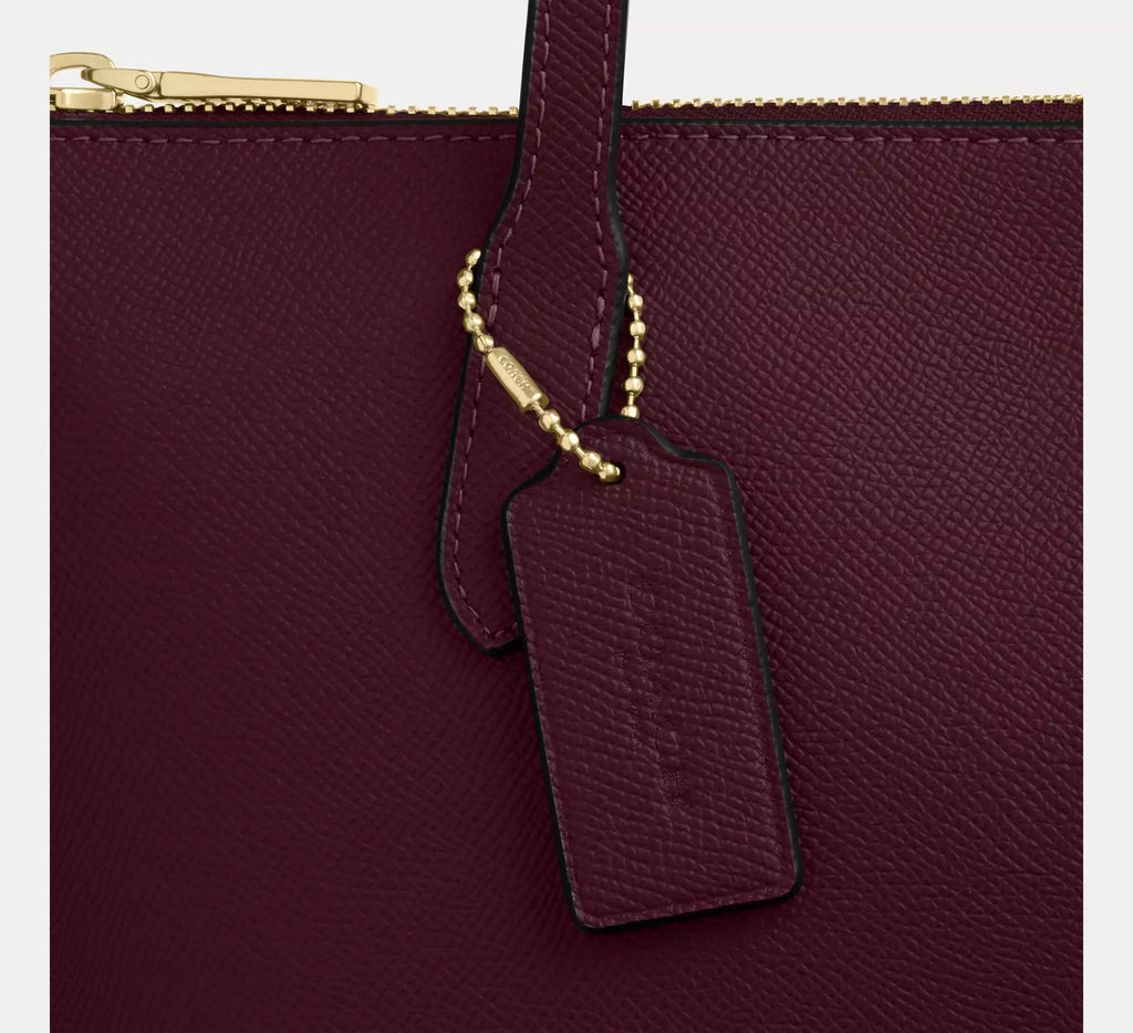 Coach CW395 Fiona Zip Tote Bag in crossgrain leather with gold and dark wine accents, featuring a spacious interior and sleek design.