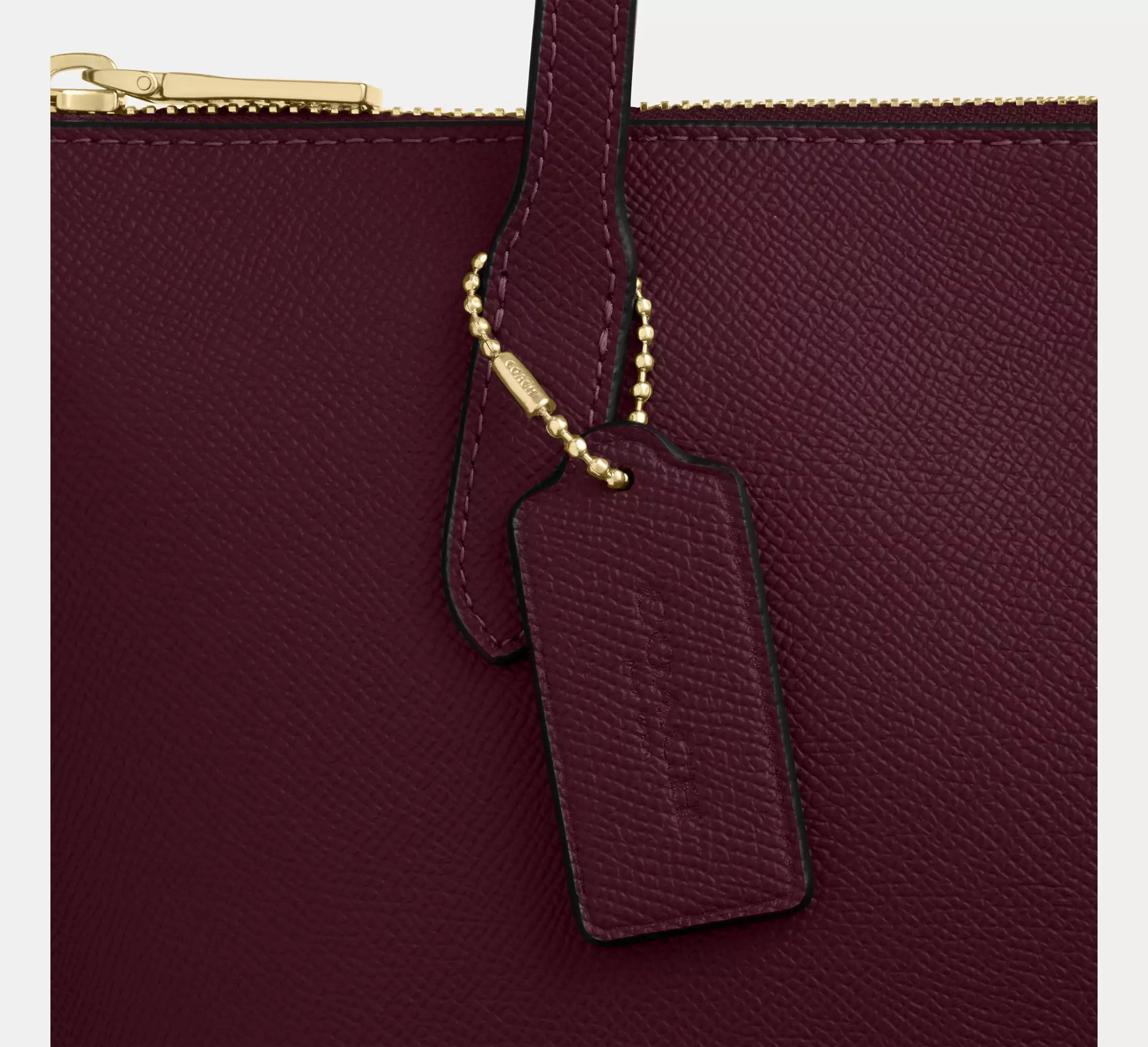 Coach CW395 Fiona Zip Tote Bag in crossgrain leather with gold and dark wine accents, featuring a spacious interior and sleek design.