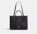 Black Coach Maggie large tote bag in signature leather, featuring sturdy shoulder straps and spacious interior.