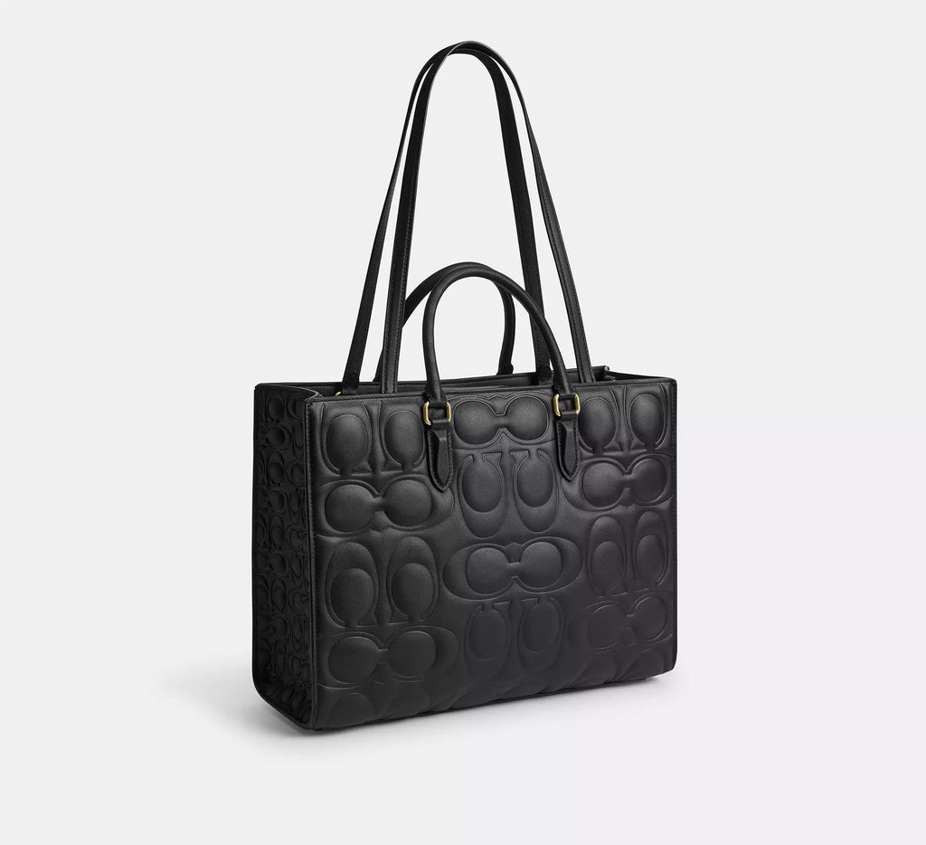 Black Coach Maggie large tote bag made of signature leather, featuring shoulder strap and spacious interior.