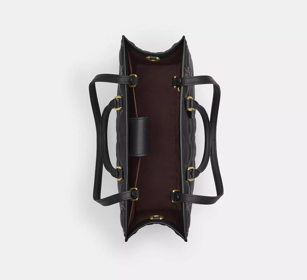 Black Coach Maggie large tote shoulder bag in signature leather, featuring spacious interior and sturdy handles.