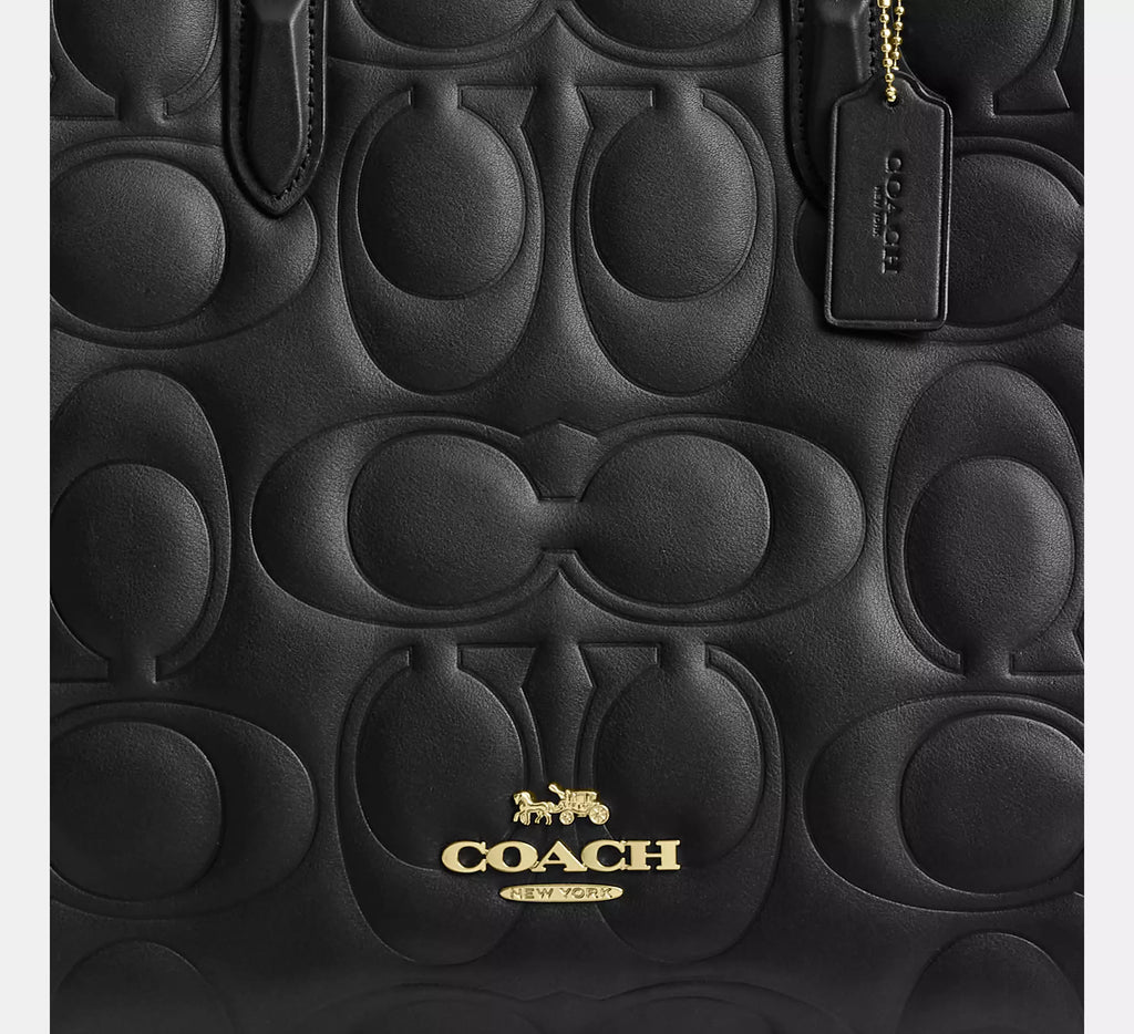 Black Coach Maggie large signature leather tote bag with shoulder straps, featuring a spacious design and sleek brand detailing.