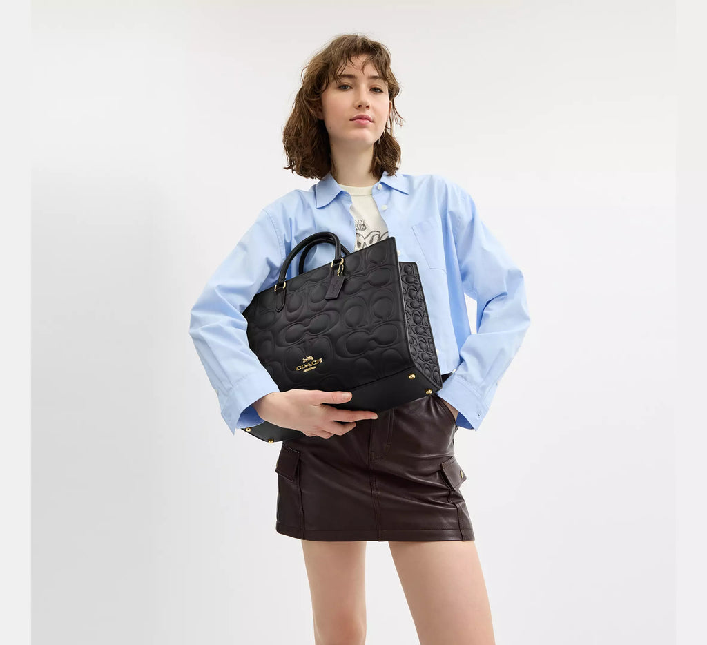 Black Coach Maggie large leather tote bag with shoulder straps and signature leather finish, stylish and spacious for everyday use.