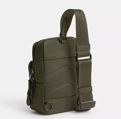 The Tiny Bag Coach Gotham Sling Pack in army green leather, small crossbody bag with adjustable strap and sleek design.