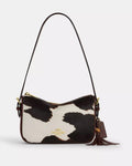 Coach Kailey crossbody shoulder bag with cow print, tassel detail, brown and white color, featuring the CCC84 logo.