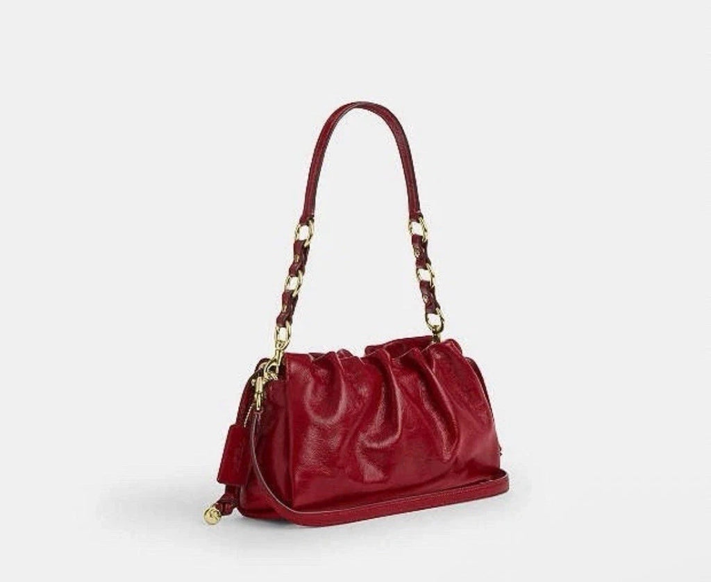 Dark cardinal Coach Faye shoulder and crossbody bag in glazed leather with gold accents, by The Tiny Bag.
