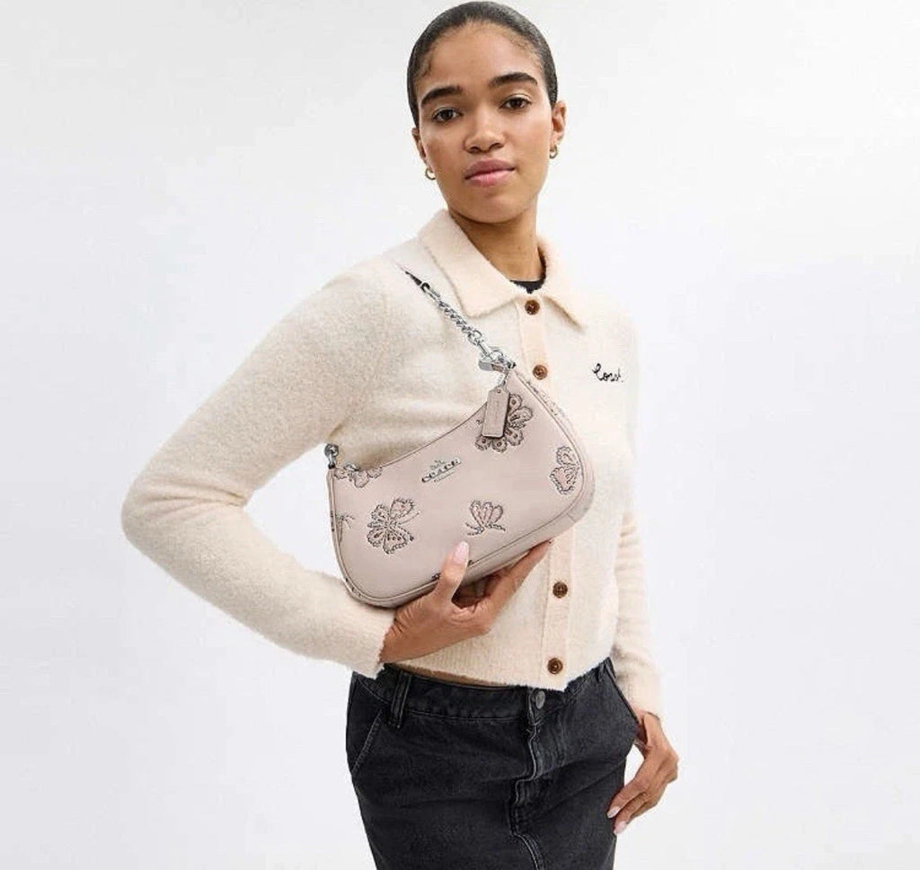 Coach Teri shoulder bag with butterfly print from The Tiny Bag, featuring a stylish design and compact size for everyday use.